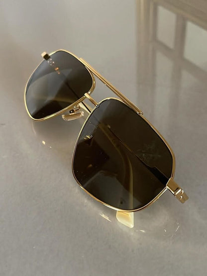 Gold-tone aviator sunglasses with dark lenses and hinge detail