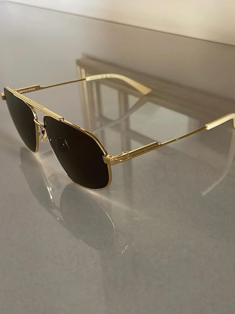 Gold-tone aviator sunglasses with dark lenses and slim metal arms