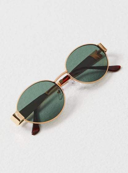 Round sunglasses with gold frame and dark green lenses, side view