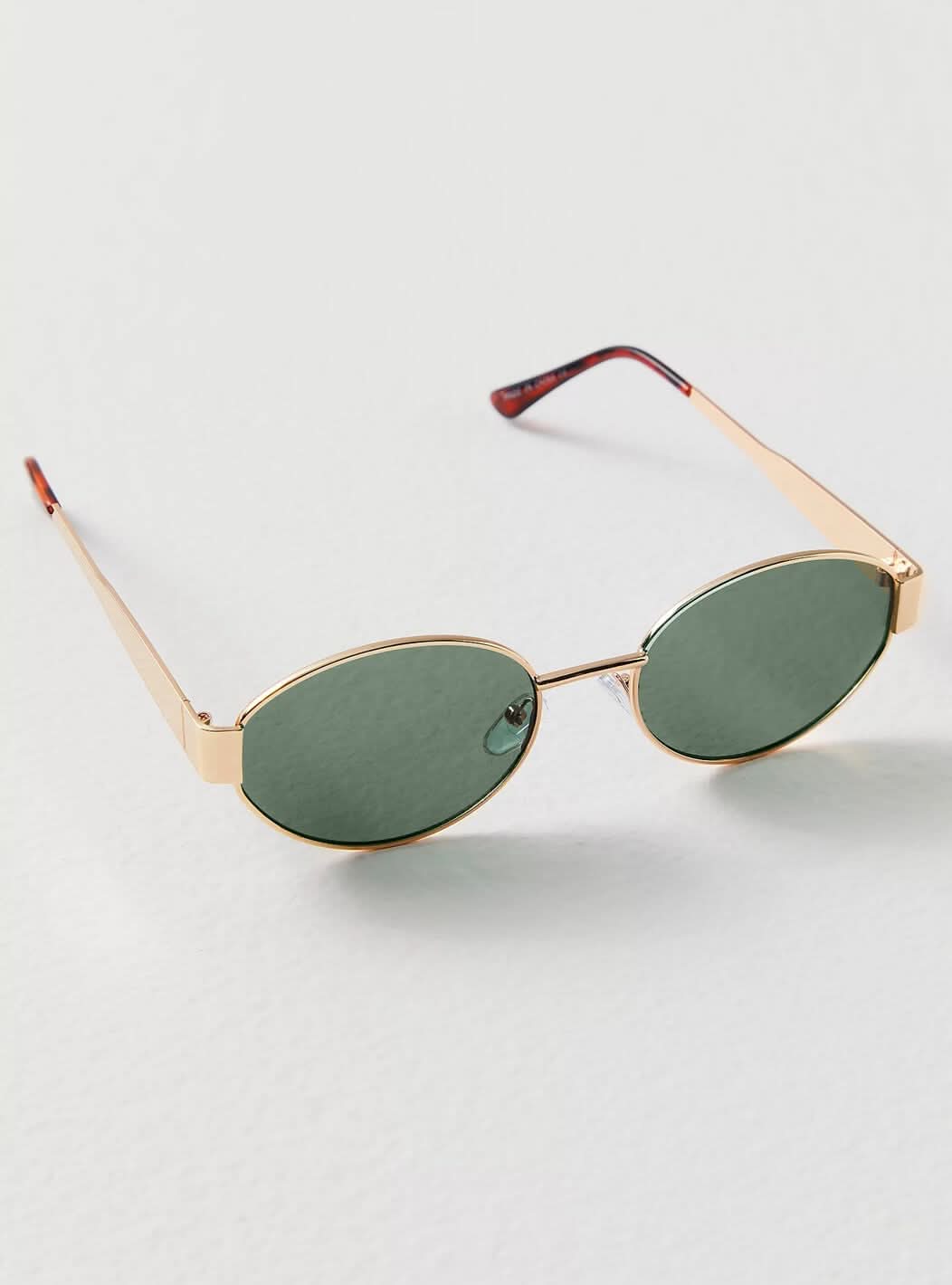 Round sunglasses with gold frame and dark green lenses, angled front view