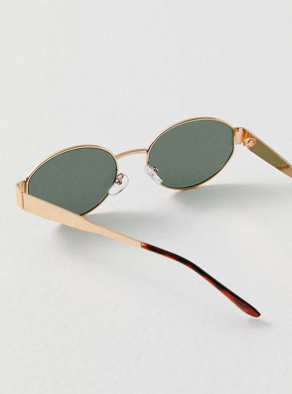 Zariyah stylish sunglasses with gold frame and green tinted oval lenses, side view