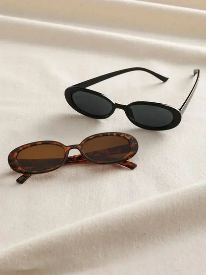 Tortoiseshell and black oval sunglasses with dark lenses, side by side