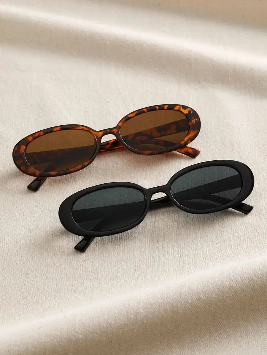 Set of tortoiseshell and black oval sunglasses with dark lenses