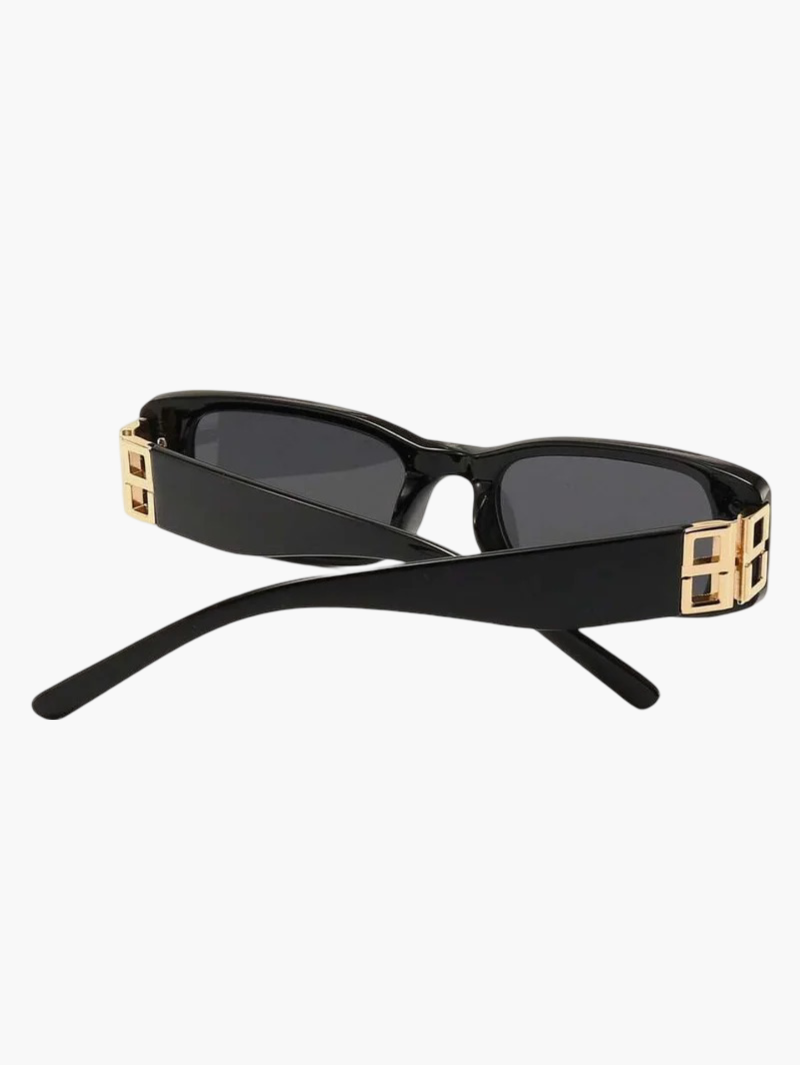 Black sunglasses side view with gold square hinge detail and dark tinted lenses