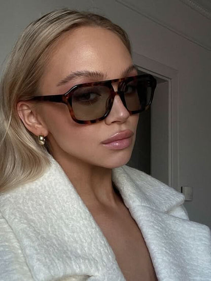 Dark tortoiseshell sunglasses with smoky lenses and square rectangular frames