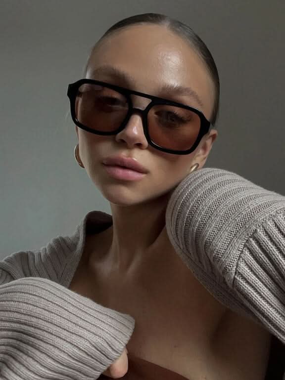 Black square sunglasses with dark lenses and gold-tone side details