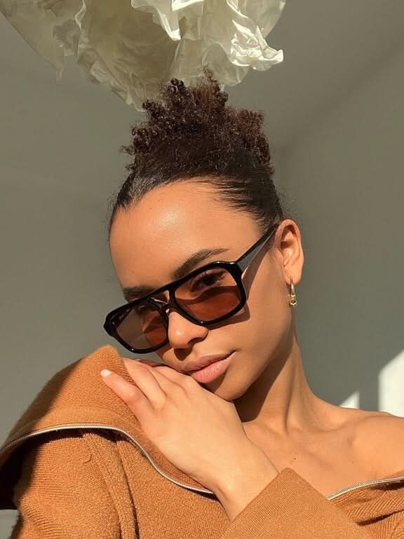 Black sunglasses with brown-tinted lenses and angular rectangular frames