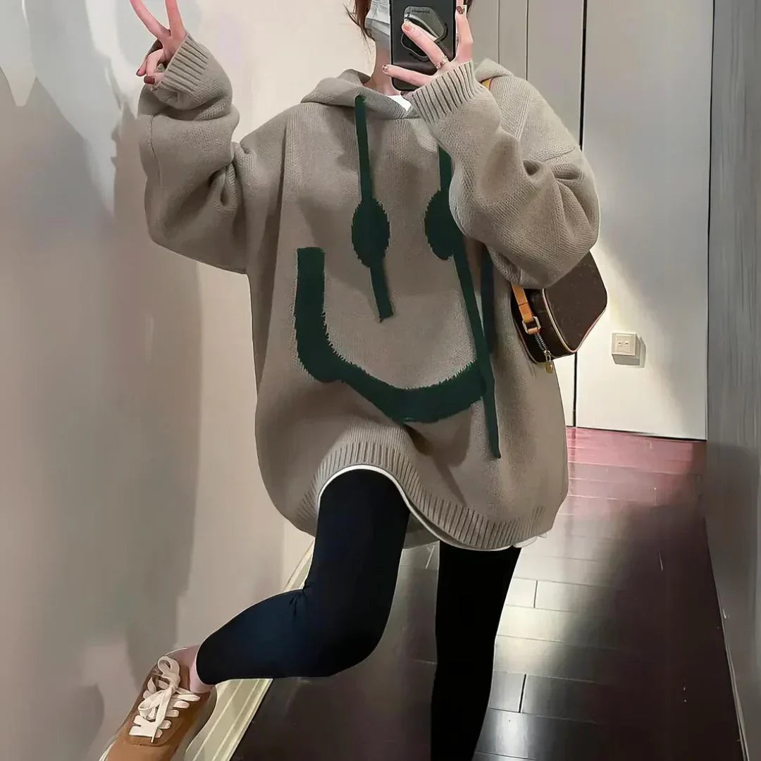 Khaki oversized hoodie with green smiley graphic, hood, and ribbed cuffs