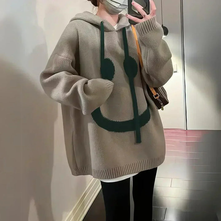 Khaki oversized hoodie with green smiley face on front, hood and kangaroo pocket