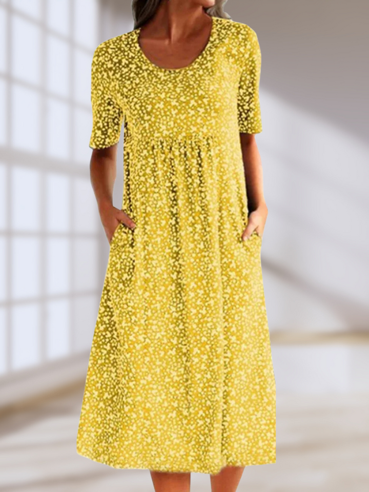 Floral summer dress in yellow with short sleeves and scoop neckline, midi length