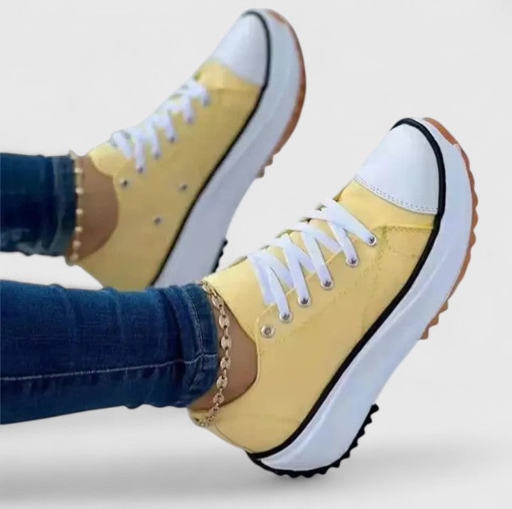 Yellow platform sneakers with white sole and lace-up, black outsole trim