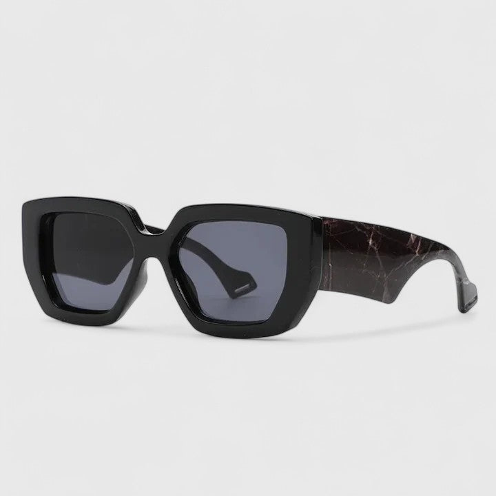 Black oversized square sunglasses with dark blue tinted lenses and marbled temple arm