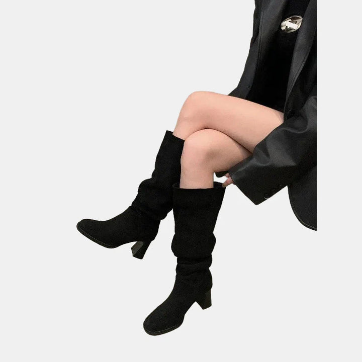 Black suede pointed-toe block-heel knee-high boots, angled side view