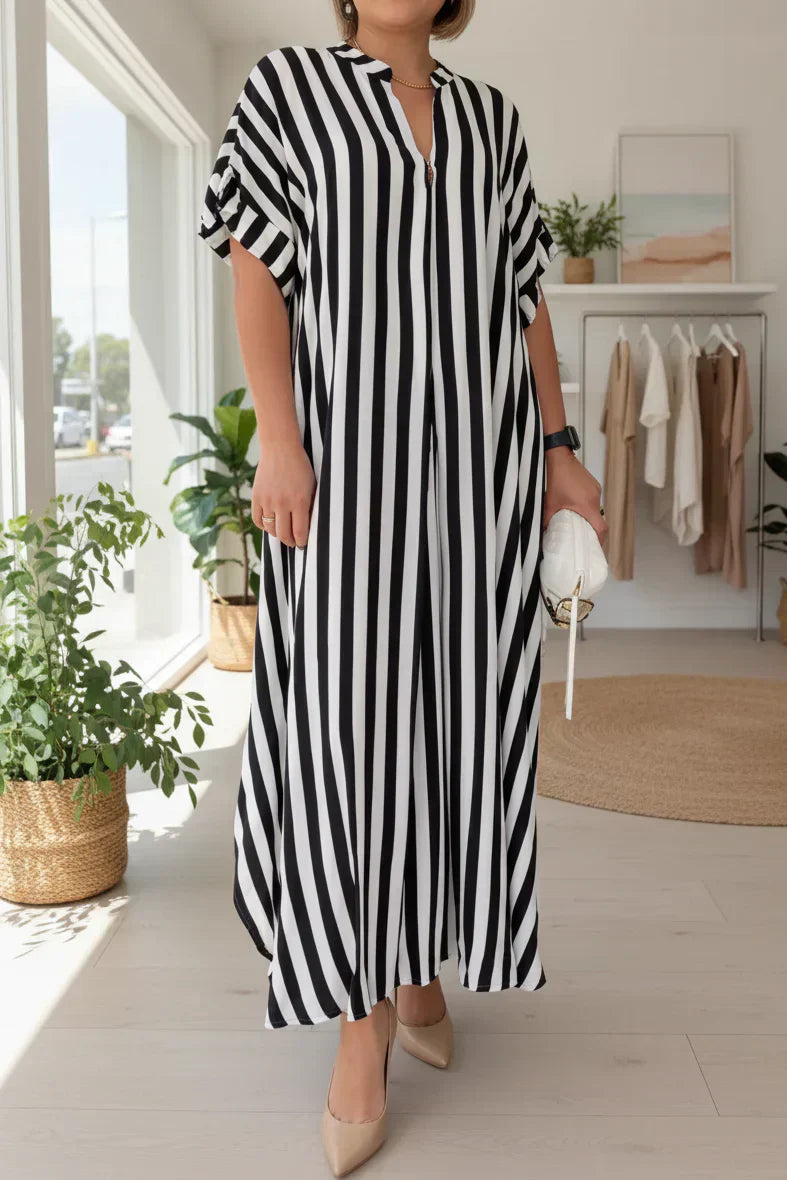 Black-and-white striped maxi dress with V-neck, short flutter sleeves, and side slit