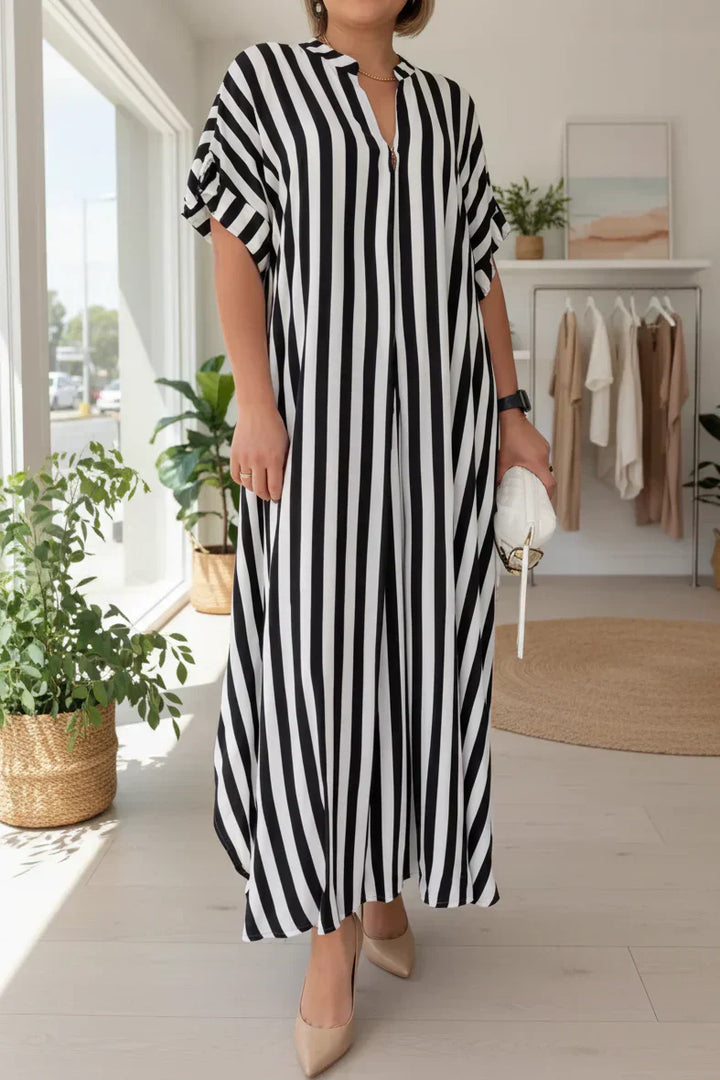 Black-and-white striped maxi dress with V-neck, short flutter sleeves, and side slit