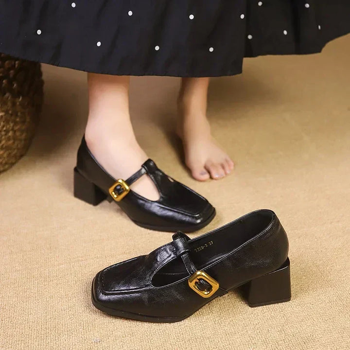 Black Mary Jane pumps with T-strap and gold buckle square toe block heel