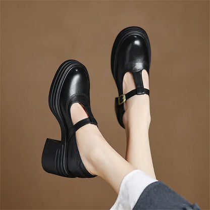 Black chunky Mary Jane pumps with buckle ankle strap and stacked sole