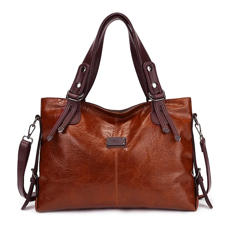 Brown soft leather tote bag with double handles and front logo patch