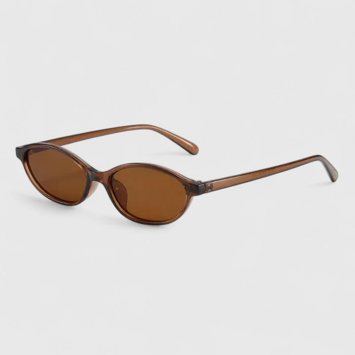 Sunglasses with brown tortoiseshell frames and amber lenses, angled side view