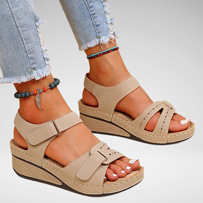 Women’s beige platform sandals with two straps and adjustable buckles on wedge sole
