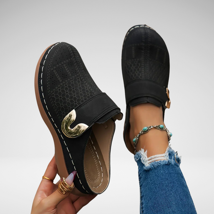 Black perforated wedge sandals with adjustable strap and gold-tone buckle detail