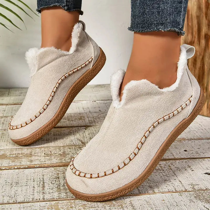 Beige orthopedic slip-on slippers with fuzzy lining and stitched seam trim