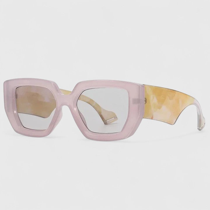 Pale pink oversized square sunglasses with light tinted lenses and yellow patterned temple arm