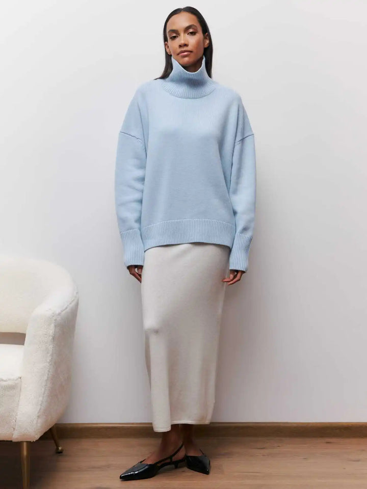 Light blue turtleneck sweater with ribbed collar, long sleeves, relaxed fit