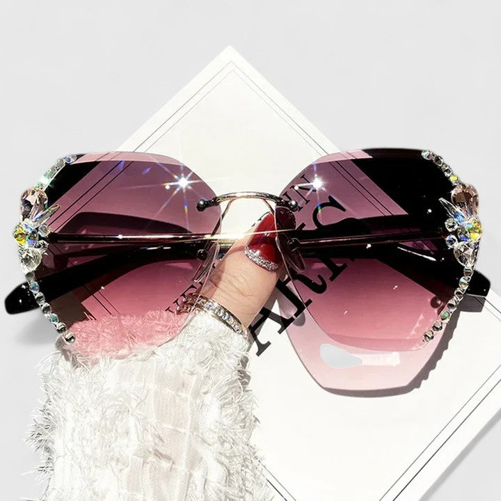 Jeweled sunglasses with rhinestone trim and purple gradient lenses