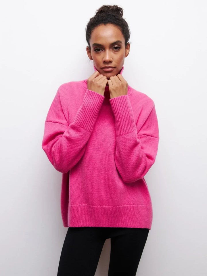 Pink turtleneck sweater with long sleeves and ribbed collar and cuffs