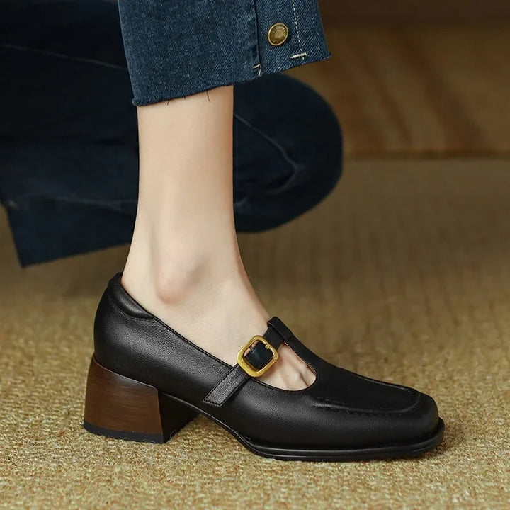 Black T-strap loafer side view with square buckle and block heel