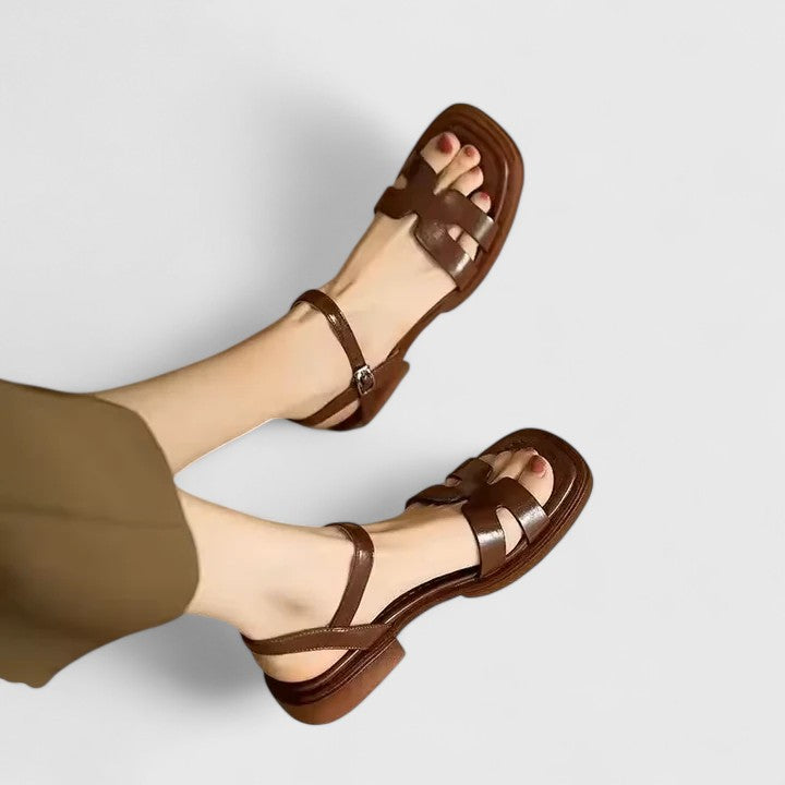 Flat thong sandals in brown with buckled ankle strap and double band upper