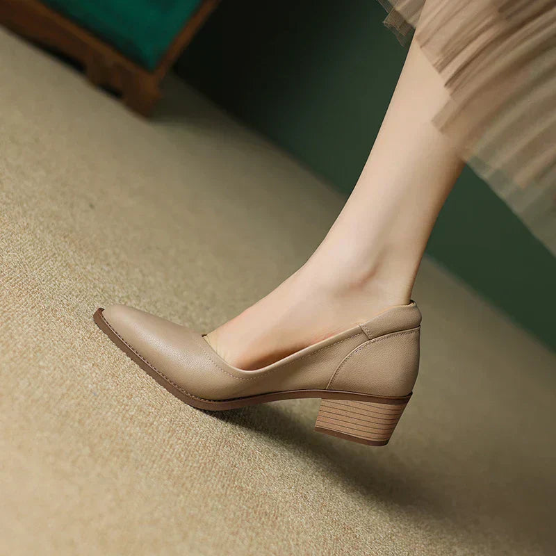 Apricot mid heeled shoes with pointed toe and low block heel, angled rear view