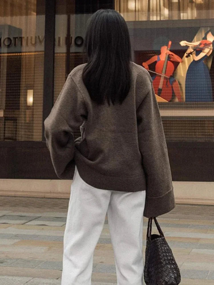 Back view of brown V-neck knit cardigan with ribbed cuffs