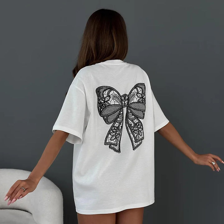 Women’s white bow tee with large black lace bow on the back, short sleeves