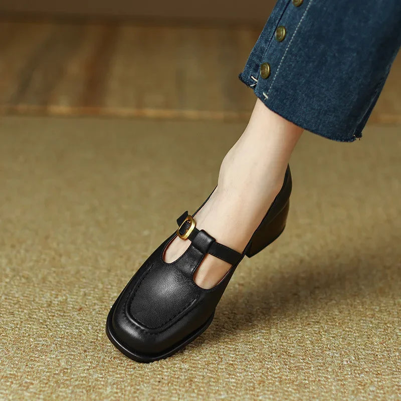 Black T-strap loafer with buckle strap across cutout vamp