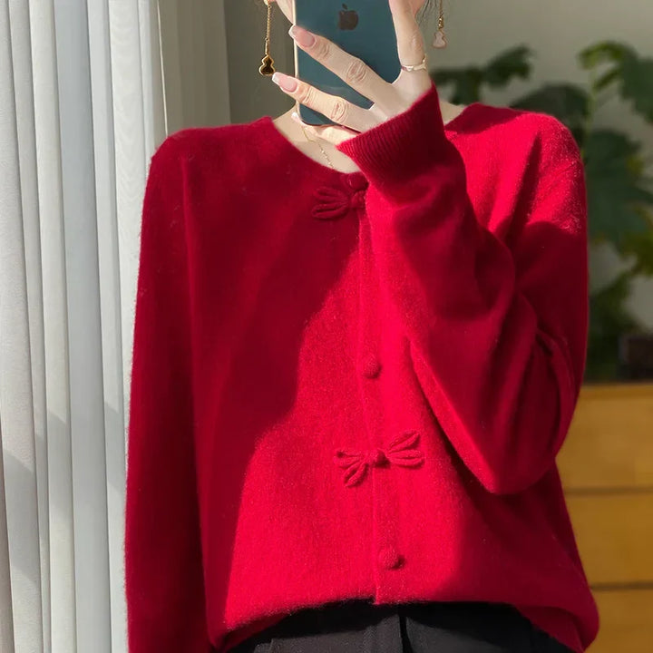 Red bow-front cardigan with button placket and bow detail at center