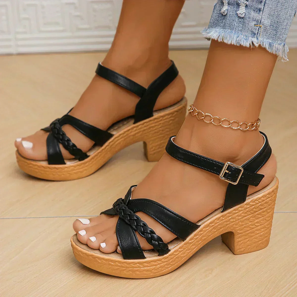 Comfortable sandals in black with braided front strap, ankle buckle, and block heel platform