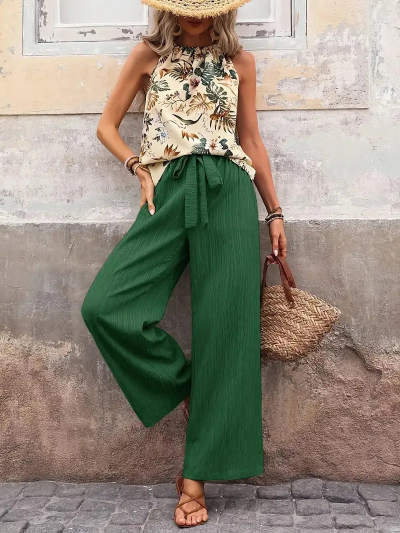 Two-piece set with sleeveless floral blouse and green wide-leg drawstring pants