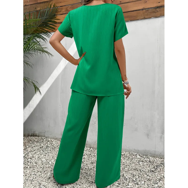 Green asymmetrical blouse and relaxed pants two-piece set, back view, short sleeves