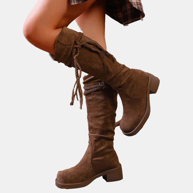 Brown suede mid-calf ankle boots, side view, chunky block heel and tied tassels