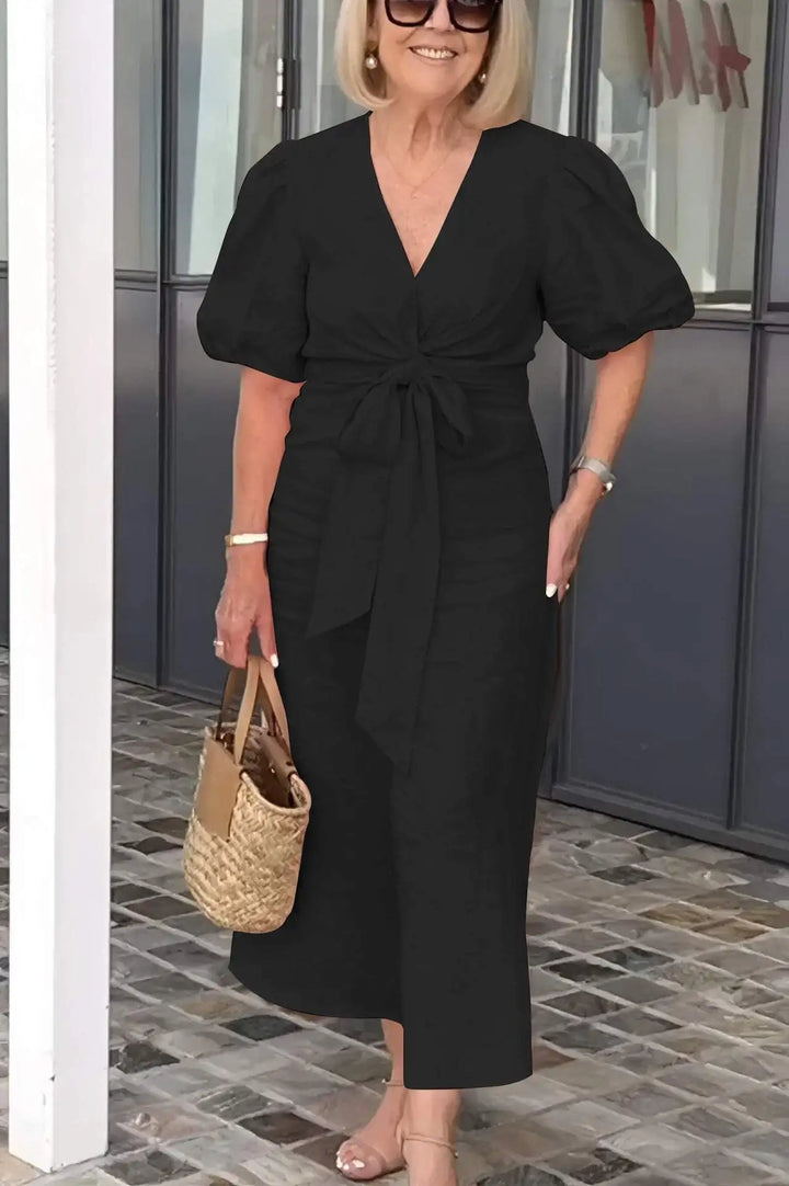 Black V-neck midi dress with puff sleeves and waist tie, front view