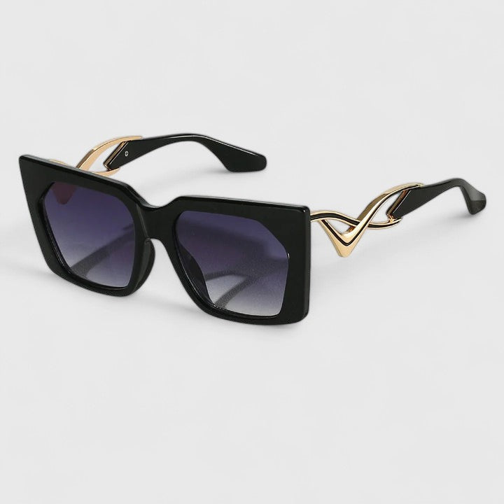 Cat-eye sunglasses with black frame and dark lenses with purple tint