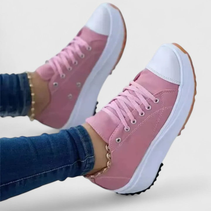 Pink platform sneakers with white sole and lace-up, matching pink upper