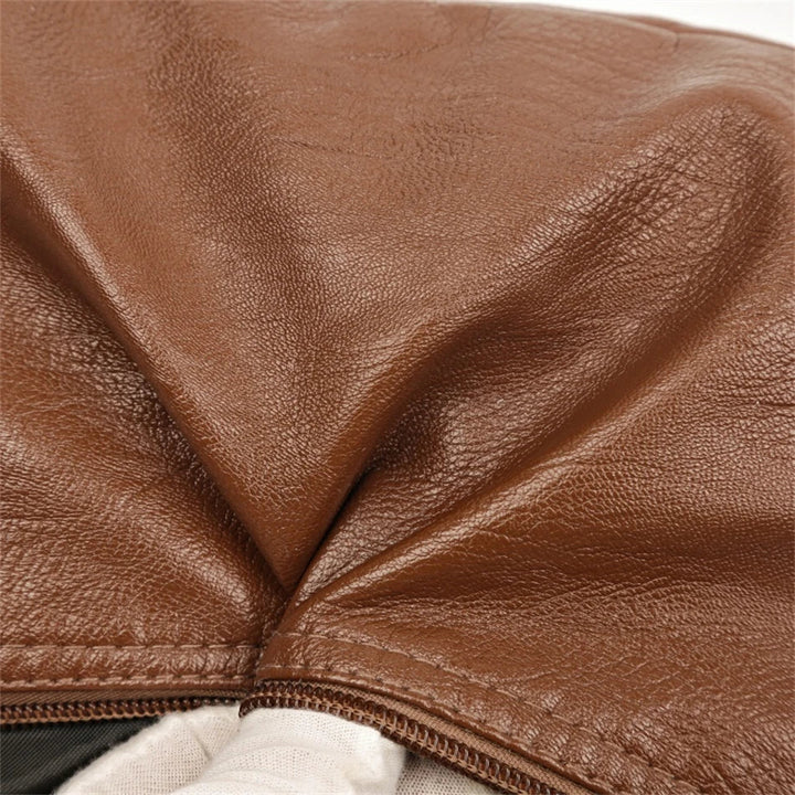 Brown leather multi-layer crossbody bag close-up of stitched panel and pocket seam