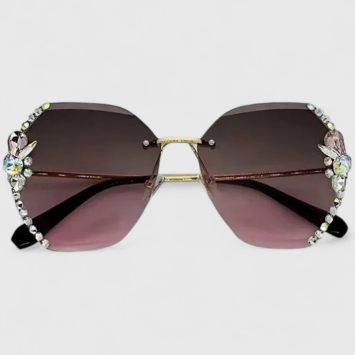 Jeweled cat-eye sunglasses with dark gradient lenses and gold double-bridge frame