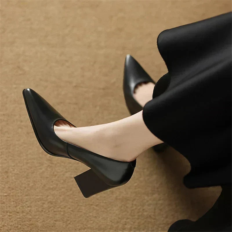 Black pointed-toe pumps with chunky block heel, side view