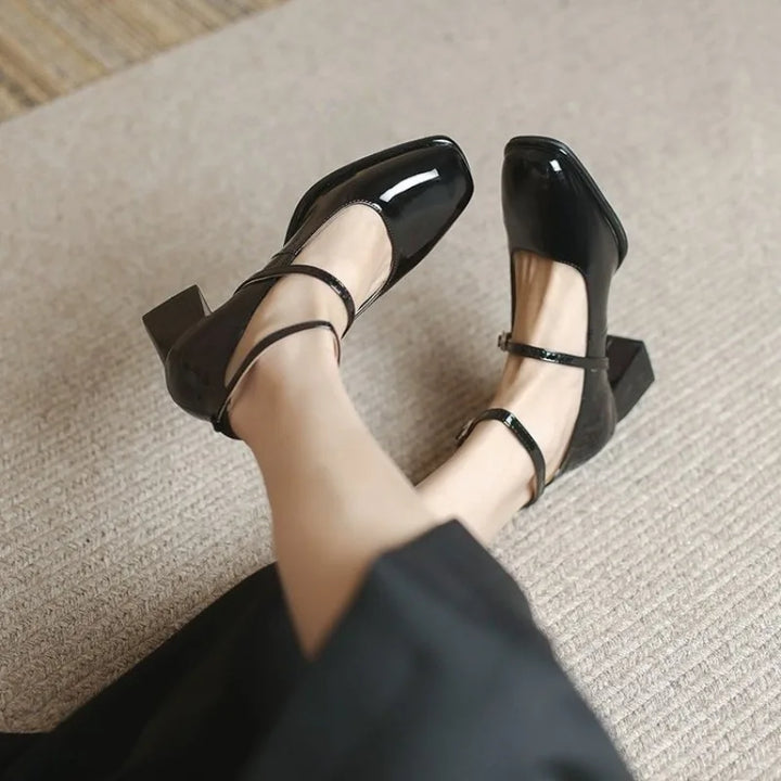 Black ankle-strap pumps with cross T-strap, low block heel, glossy finish