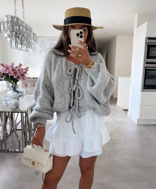 Grey knitted bow cardigan with front bow ties and long sleeves.