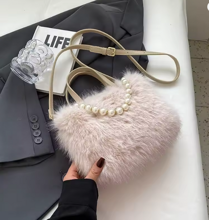Light pink faux fur crossbody bag with pearl-bead neckline and adjustable strap